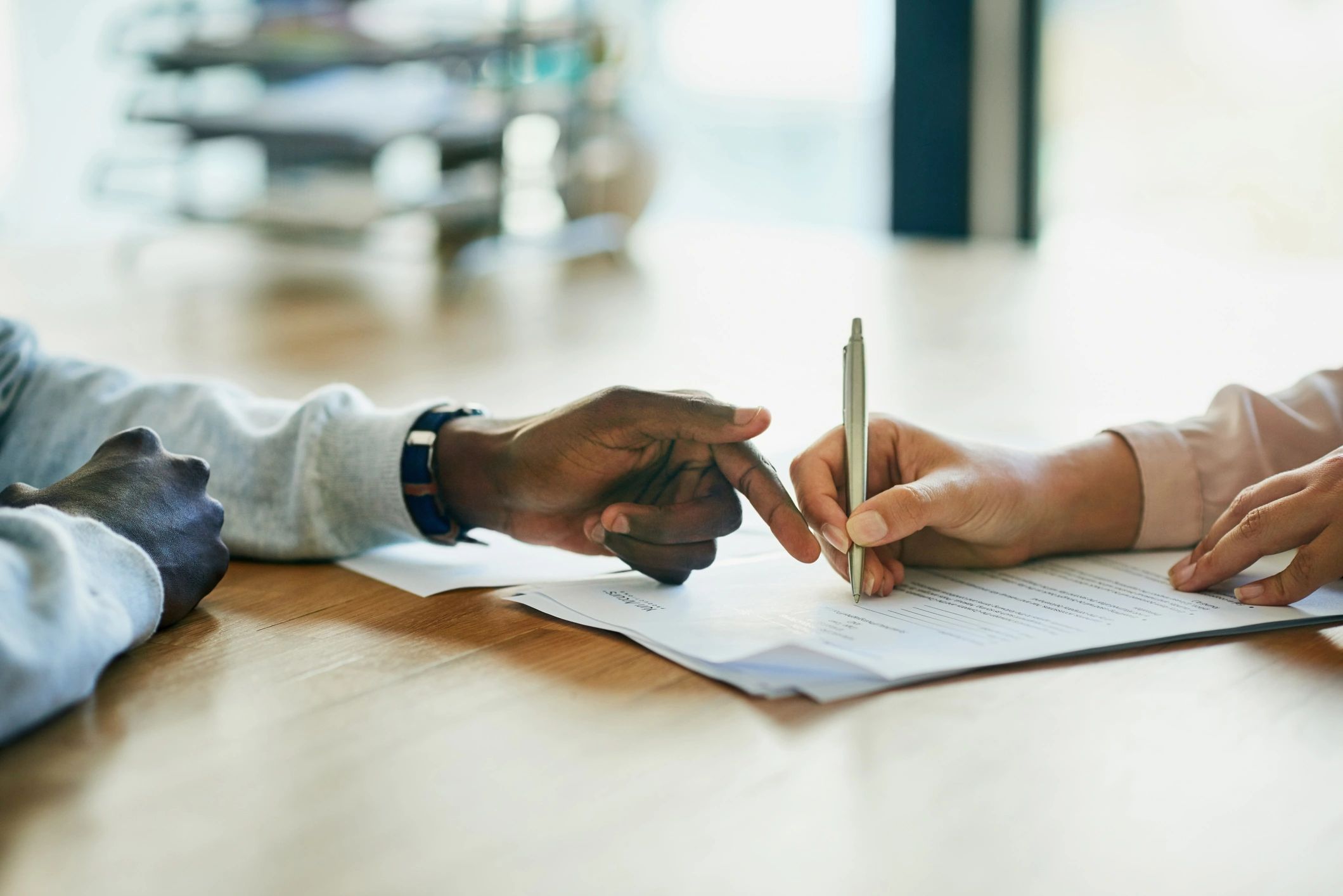 Close-up of real estate paperwork being reviewed and signed
